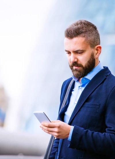 hipster-manager-with-smart-phone-london-city-hall-PBBAF8T